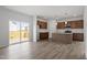 Open floor plan with a combined living room and kitchen area with island and stainless appliances at 178 Grove Township Way, Angier, NC 27501