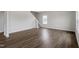 Open-concept living room showcases sleek wood-look flooring and staircase access at 178 Grove Township Way, Angier, NC 27501