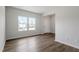 Inviting living room featuring sleek wood-look flooring, bright windows, and neutral walls at 178 Grove Township Way, Angier, NC 27501