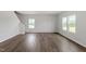 Spacious living room featuring wood-look flooring, plenty of light, and staircase access at 178 Grove Township Way, Angier, NC 27501