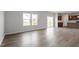 Spacious living room featuring wood-look floors that transition seamlessly into the adjacent kitchen at 178 Grove Township Way, Angier, NC 27501