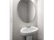 Powder room featuring a white pedestal sink and round mirror at 178 Grove Township Way, Angier, NC 27501