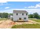 Rear exterior of a two-story home with a wood deck, sliding glass door, and light siding at 178 Grove Township Way, Angier, NC 27501