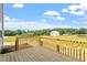 New wooden deck with a view of the yard and neighborhood under a blue sky with fluffy clouds at 178 Grove Township Way, Angier, NC 27501