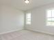 The bedroom has neutral carpet with great windows at 1813 Bright Lantern Way, Wendell, NC 27591