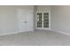 Open bonus room with double doors, plush carpeting, and natural light for a flexible living space at 1813 Bright Lantern Way, Wendell, NC 27591