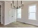 Bright dining room features modern chandelier, neutral walls, and hardwood floors at 1813 Bright Lantern Way, Wendell, NC 27591