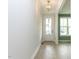 Bright entryway featuring light wood floors, white walls, and a modern light fixture at 1813 Bright Lantern Way, Wendell, NC 27591