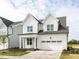 Elegant two-story home boasting a white exterior, prominent gables, and a convenient attached garage at 1813 Bright Lantern Way, Wendell, NC 27591