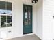 Close-up of a green front door with glass panels, set against a white-trimmed exterior at 1813 Bright Lantern Way, Wendell, NC 27591