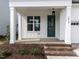 Inviting front porch with brick steps, classic columns, and a stylish green front door with sidelight at 1813 Bright Lantern Way, Wendell, NC 27591