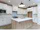 Modern kitchen featuring white cabinetry, a center island, and stainless steel appliances at 1813 Bright Lantern Way, Wendell, NC 27591