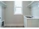 Functional laundry room with white cabinets, sink, and a window for natural light at 1813 Bright Lantern Way, Wendell, NC 27591