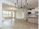 Open-concept living area with light hardwood flooring and ample natural light at 1813 Bright Lantern Way, Wendell, NC 27591