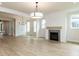 Spacious living room with a fireplace, hardwood floors, and neutral tones at 1813 Bright Lantern Way, Wendell, NC 27591