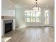 Bright living room with fireplace, hardwood floors, and access to the outdoors at 1813 Bright Lantern Way, Wendell, NC 27591