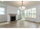 Inviting living room with shiplap accent wall, fireplace, and bright windows at 1813 Bright Lantern Way, Wendell, NC 27591