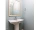 Stylish powder room featuring a pedestal sink and modern fixtures at 1813 Bright Lantern Way, Wendell, NC 27591