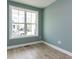 Cozy room with light green walls, white trim, and ample natural light from a large window at 1813 Bright Lantern Way, Wendell, NC 27591