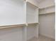 Walk-in closet featuring wooden shelving, hanging rods, and carpeted flooring for organized storage at 1813 Bright Lantern Way, Wendell, NC 27591