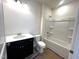 A bright bathroom features a vanity with a black cabinet and a shower-tub combo at 19 E American Marigold Dr # 34, Benson, NC 27504