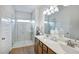 Modern bathroom with a double sink vanity, tile flooring, and a glass-enclosed shower at 19 E American Marigold Dr # 34, Benson, NC 27504