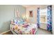 Bright bedroom featuring a large window, vibrant colors, and unique animal-themed wall art at 19 E American Marigold Dr # 34, Benson, NC 27504