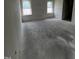 This bedroom features bare walls, concrete floors, and two windows offering ample natural light at 19 E American Marigold Dr # 34, Benson, NC 27504
