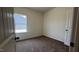 Cozy bedroom with neutral walls, carpeted floor, and a window letting in natural light at 19 E American Marigold Dr # 34, Benson, NC 27504