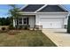 Charming single-Gathering home featuring a two-car garage, stone accents, and a well-manicured lawn at 19 E American Marigold Dr # 34, Benson, NC 27504