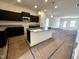 Open-concept kitchen with dark cabinets, granite countertops, and modern stainless steel appliances at 19 E American Marigold Dr # 34, Benson, NC 27504