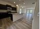 Modern kitchen with dark cabinets, granite countertops, stainless steel appliances and open to the living area at 19 E American Marigold Dr # 34, Benson, NC 27504