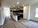 Spacious kitchen with dark cabinetry, granite island and modern lighting ready for entertaining at 19 E American Marigold Dr # 34, Benson, NC 27504