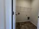 Convenient laundry room with shelving, utility connections, and durable flooring for easy maintenance at 19 E American Marigold Dr # 34, Benson, NC 27504