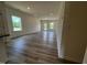 Spacious living room with wood-look floors, abundant natural light, and a welcoming ambiance at 19 E American Marigold Dr # 34, Benson, NC 27504