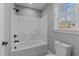 Bathroom shower and toilet, with black hardware, and a window at 20 Wes Sandling Rd, Franklinton, NC 27525