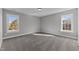 Bright bedroom with carpet flooring and two large windows at 20 Wes Sandling Rd, Franklinton, NC 27525