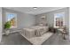 Bedroom featuring a bed, area rug, two bedside tables and two windows at 20 Wes Sandling Rd, Franklinton, NC 27525