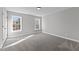 Spacious bedroom with carpet flooring and two windows at 20 Wes Sandling Rd, Franklinton, NC 27525