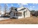 Side view of a two-story house with stone and shingle exterior and a front porch at 20 Wes Sandling Rd, Franklinton, NC 27525