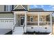 Charming front porch with stone accents and a black front door at 20 Wes Sandling Rd, Franklinton, NC 27525
