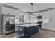 Modern kitchen featuring white cabinets, stainless steel appliances, and a center island at 20 Wes Sandling Rd, Franklinton, NC 27525