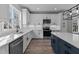 Modern kitchen with white cabinets, stainless steel appliances and a large island at 20 Wes Sandling Rd, Franklinton, NC 27525