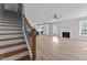 Open-concept living area showcasing a staircase, fireplace, kitchen, and hardwood floors at 20 Wes Sandling Rd, Franklinton, NC 27525