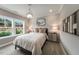 Cozy bedroom with large windows and a stone accent wall at 204 E Fountainhead Ln, Garner, NC 27529