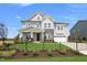 Two story house with gray siding, stone accents, and a black fence at 204 E Fountainhead Ln # Marlette 169, Garner, NC 27529