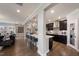 Modern kitchen with dark cabinets, quartz countertops, and stainless steel appliances at 204 E Fountainhead Ln, Garner, NC 27529