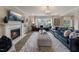 Relaxing living room featuring a fireplace and large windows at 204 E Fountainhead Ln, Garner, NC 27529