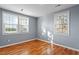 Bright bedroom with hardwood floors and two large windows at 2041 Grassy Creek Virgilina Rd, Oxford, NC 27565
