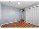 Light gray bedroom with wood flooring and double door closet at 2041 Grassy Creek Virgilina Rd, Oxford, NC 27565